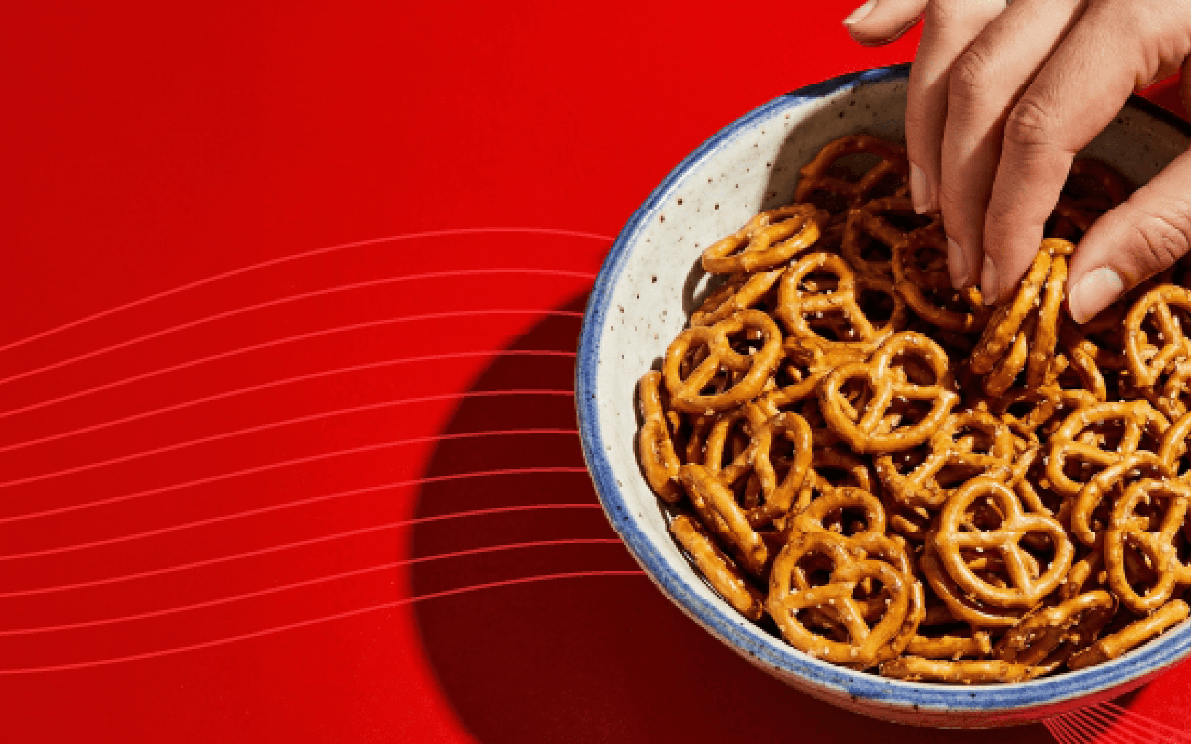 Hand in pretzel bowl